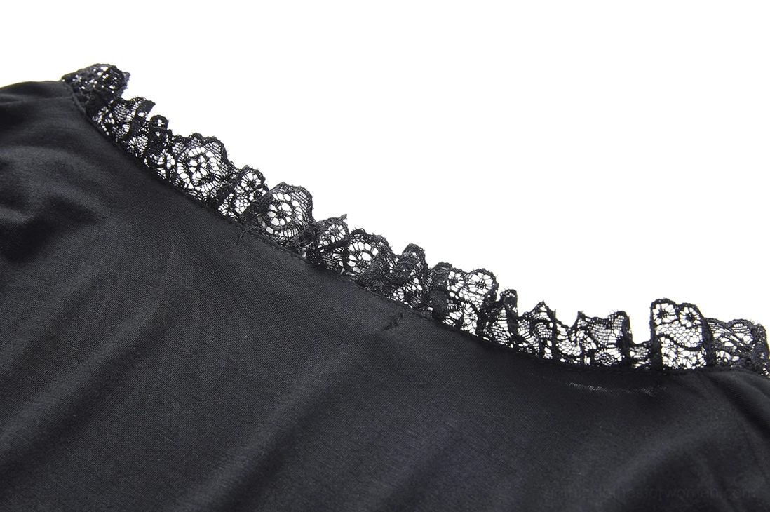 Flat close-up of floral lace ruffle trim on smooth black stretch fabric gothic top