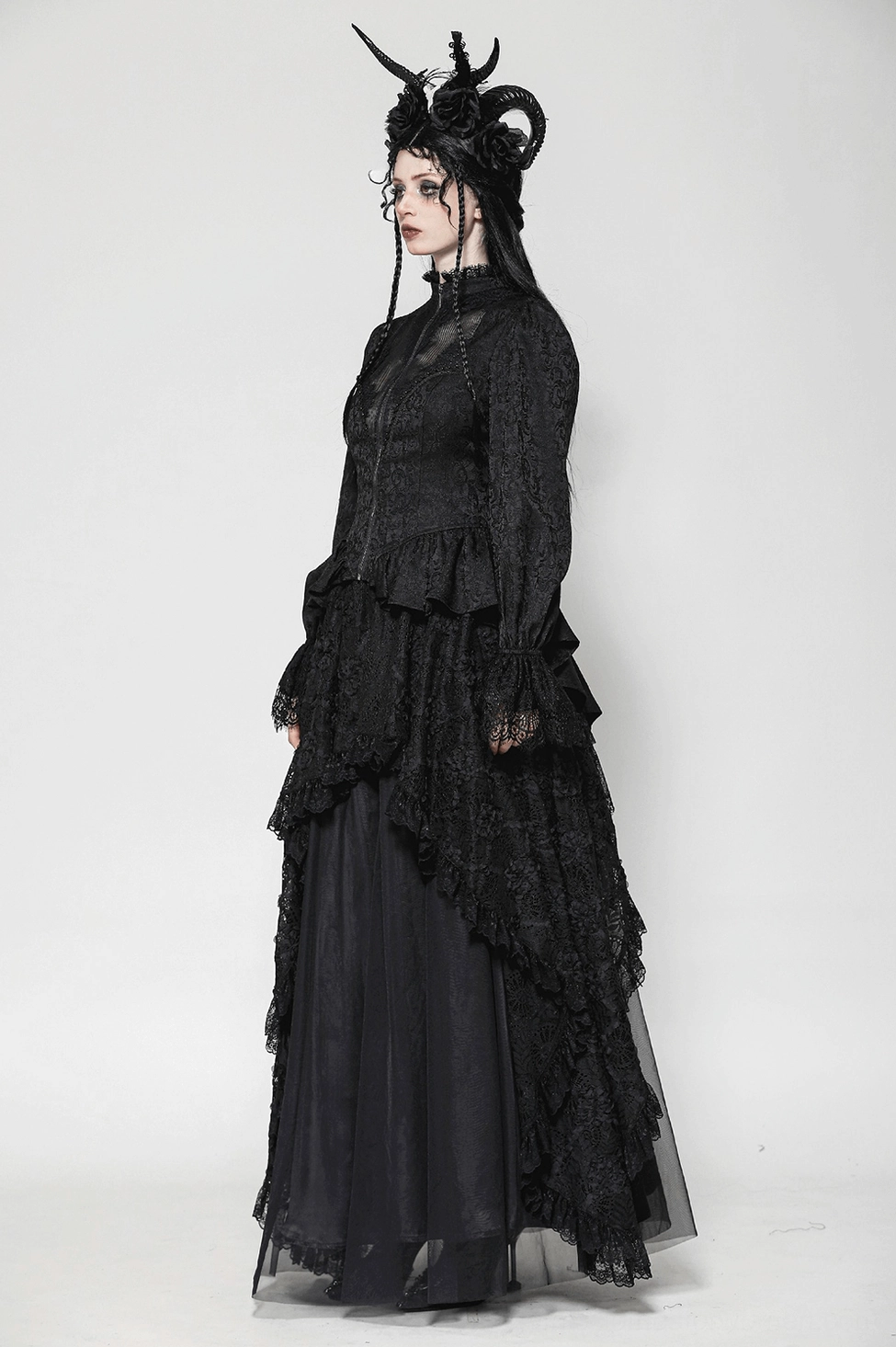Front angled view of black lace tailcoat displaying corset waist definition and sheer puffed sleeves