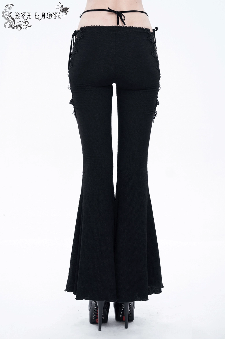 Full-length wear view of black lace-up flared gothic pants demonstrating fit and flow