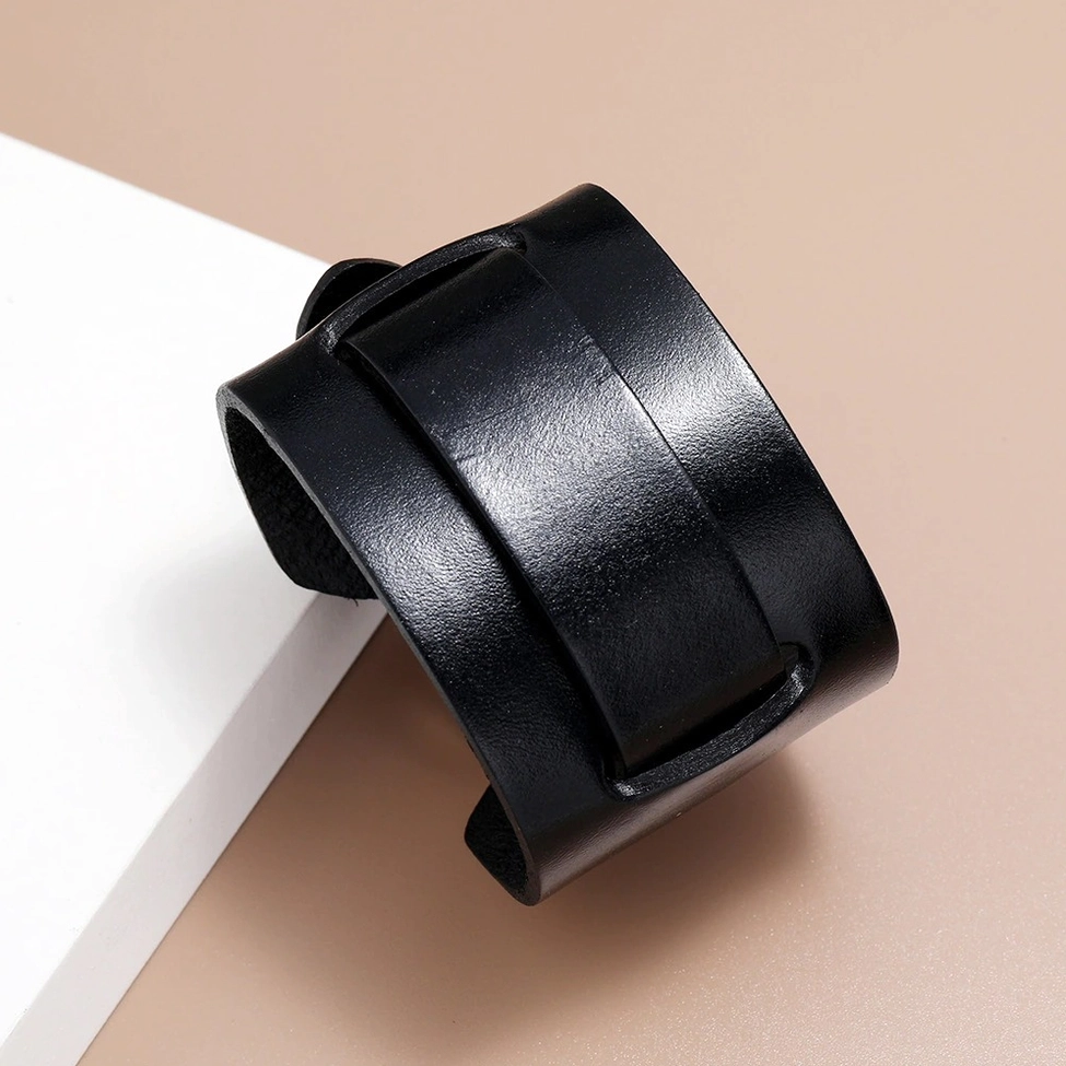 Black leather cuff bracelet with smooth polished finish and double strap detail, 3/4 side overhead angle