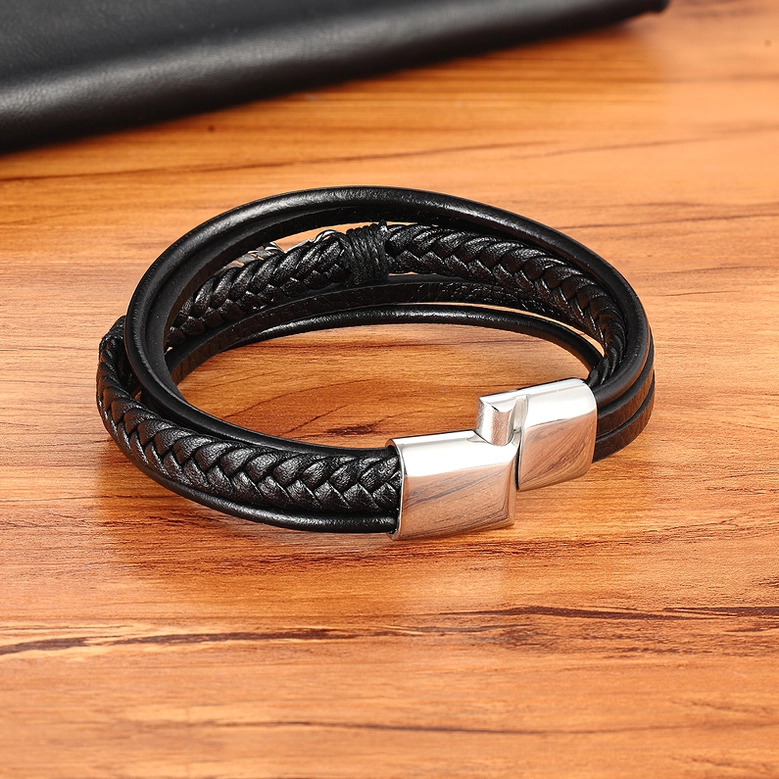 Multi-layer braided black genuine leather gothic bracelet with silver magnetic clasp, top-down flat lay view