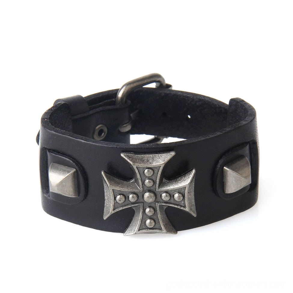 Black leather gothic cross bracelet flat lay, displaying metal cross ornament and adjustable strap with toggle clasp