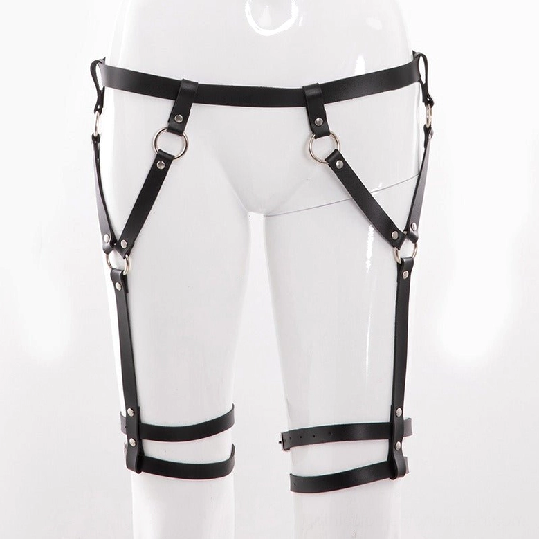 Black faux leather body harness detail showing buckle mechanism and adjustable strap system engineering