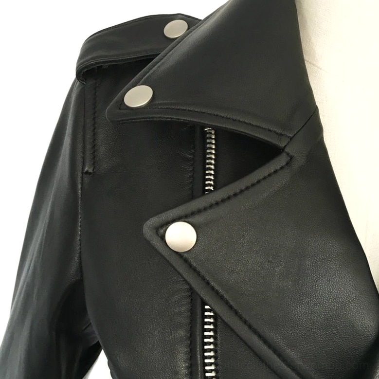 Close-up detail view of women's black sheepskin leather motorcycle jacket showing silver hardware, zipper construction, and material texture