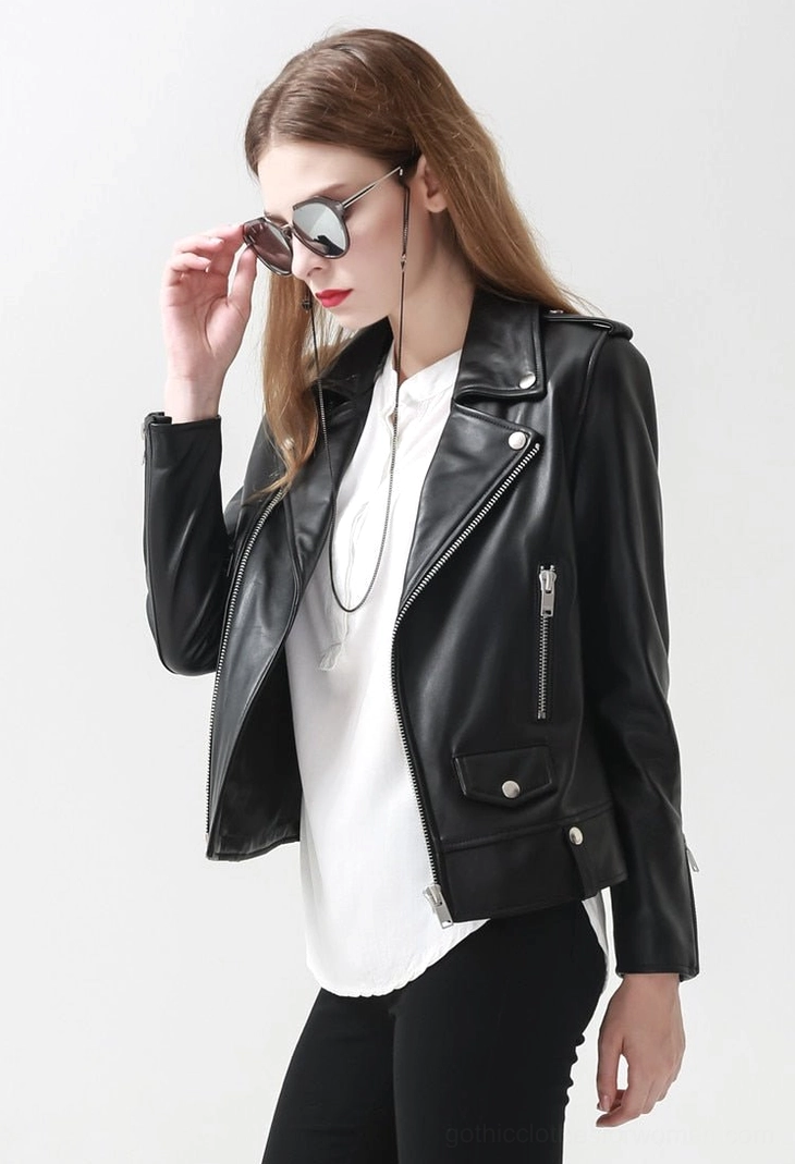 Detail view of women's black sheepskin leather jacket showing snap waist buttons, flap pockets, and premium genuine leather surface finish