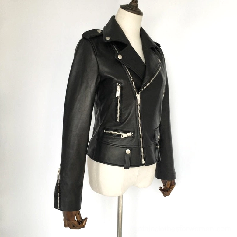Three-quarter front view of women's black sheepskin leather biker jacket on dress form, displaying zipper pockets and silver hardware accents