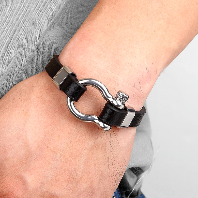 Silver stainless steel black leather toggle clasp bracelet worn on male wrist, side profile showing industrial style