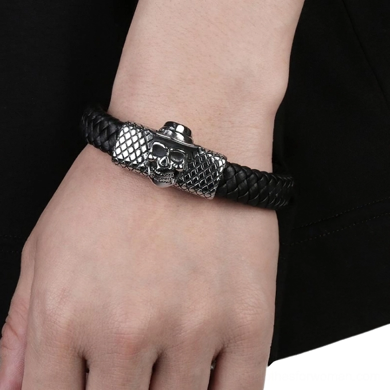 Gothic leather skull bracelet worn on male wrist, demonstrating fit and styling against dark clothing background, showing fedora-wearing skull charm and braided construction
