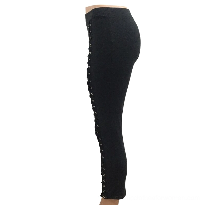 Black slim fit leggings with side lace-up gothic details, showing profile view of hollow cutout design