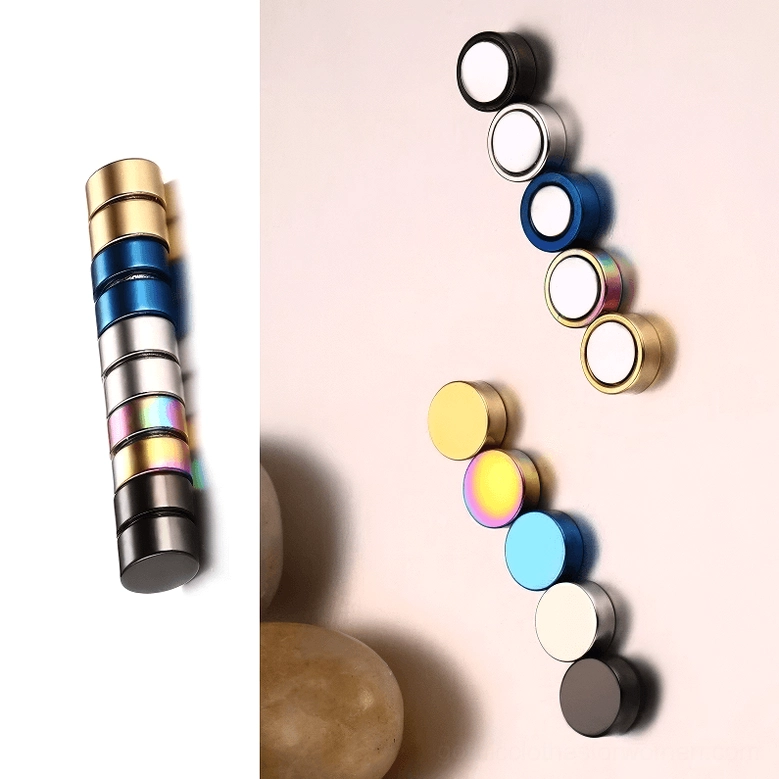 Black magnetic stud earring detail shot, high-polished stainless steel round gothic minimalist aesthetic