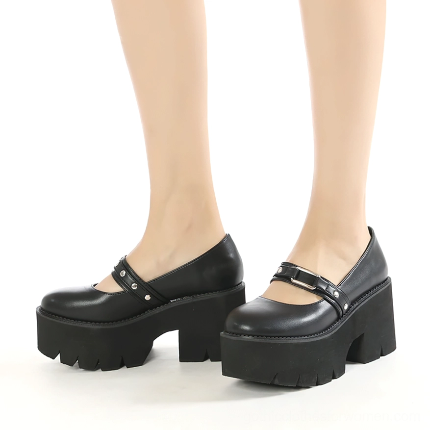Worn black platform Mary Jane shoes on female legs, front three-quarter view showing overall wearing effect and silhouette
