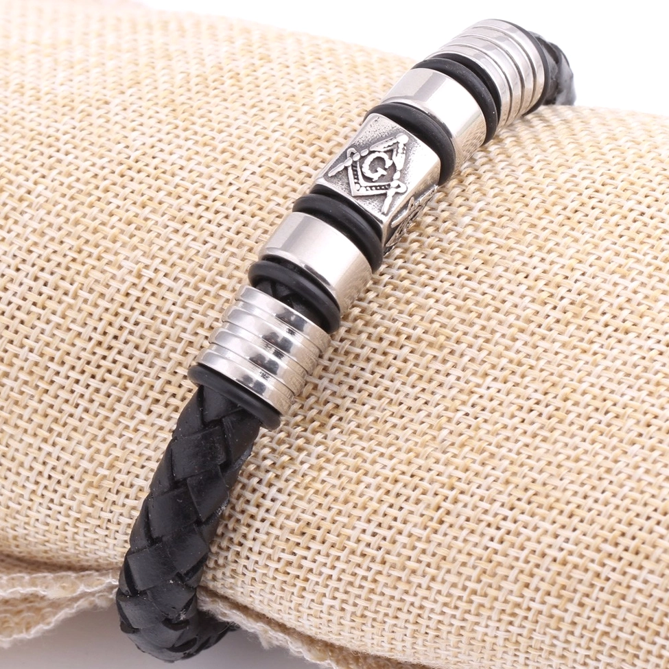 Black leather Masonic gothic bracelet front view on linen backdrop with embossed emblem and magnetic fastening