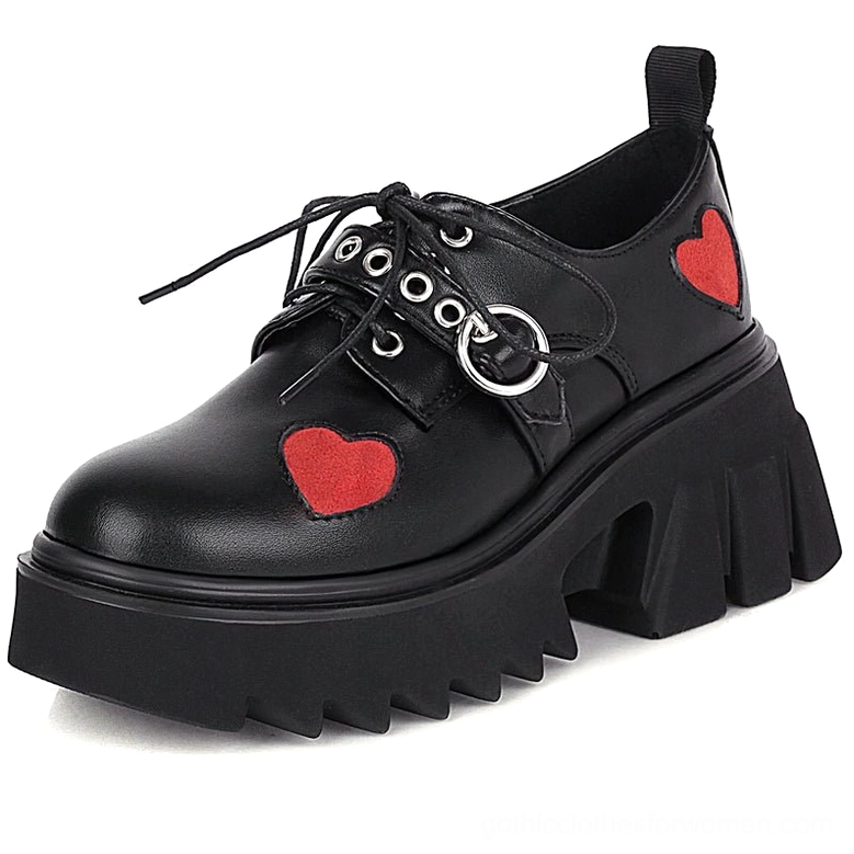 Matte black PU leather platform lace-up pumps featuring red heart appliqué and chunky rubber lug sole, side angle