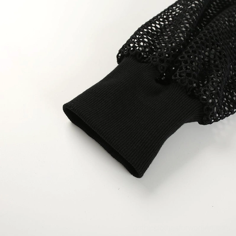 Black mesh crop top close-up detail showing ribbed knit cuff and transparent fishnet fabric texture