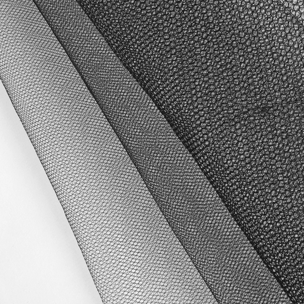 Close-up of black hexagonal mesh texture showing sheer woven fabric construction detail