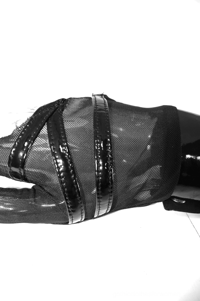 Black mesh fingerless glove showing dual patent leather wrist strap details on mannequin hand