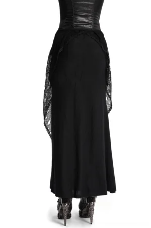 Side rear angle of black gothic maxi skirt with hanging mesh panel detail, styled with high heel boots
