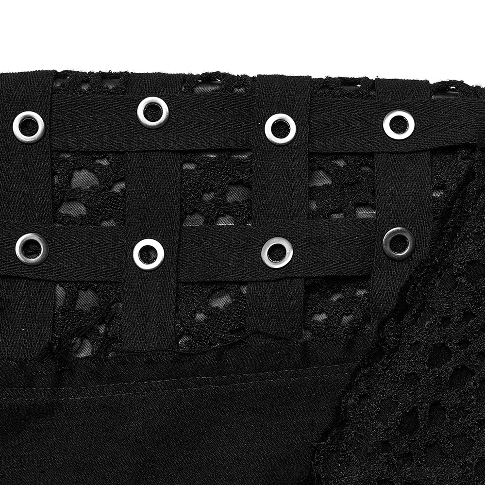 Macro close-up of metal eyelet grommets and cross lacing on gothic skinny pants - industrial hardware detail