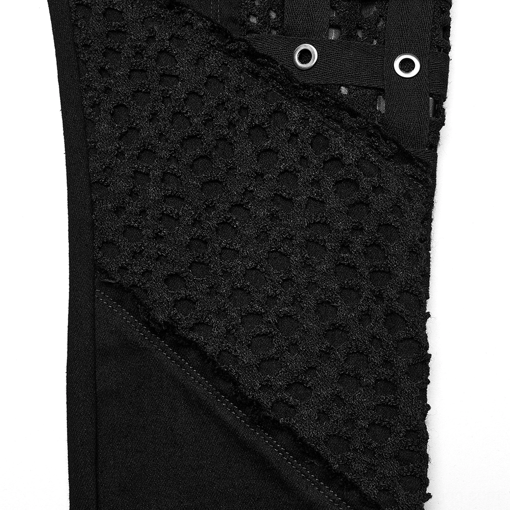 Close-up macro of black mesh grommet panel on gothic skinny pants - hollow mesh fabric texture
