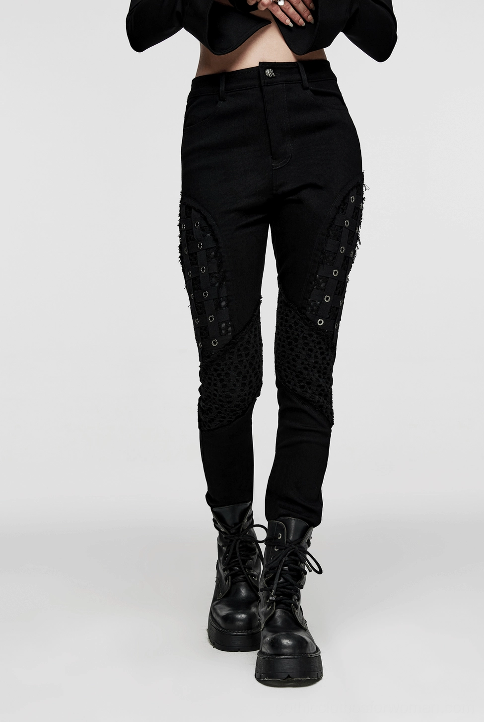 Black mesh grommet gothic skinny pants product photography - alternative punk fashion wear