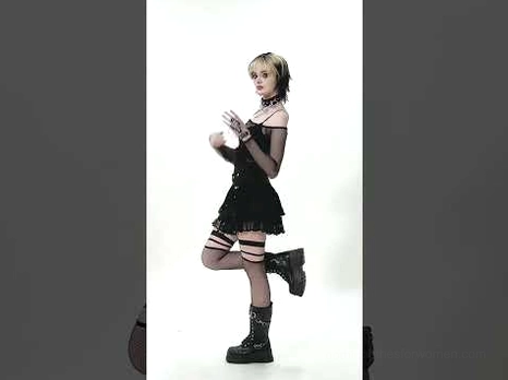 Black mesh off-shoulder gothic top worn with platform boots and fishnet stockings