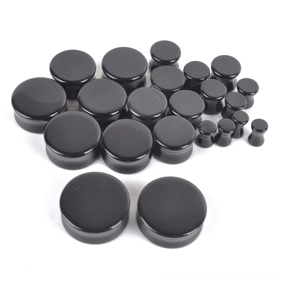 Front view of round black obsidian ear gauge plugs displaying the flat polished surface and deep black stone finish perfect for gothic style ear stretching
