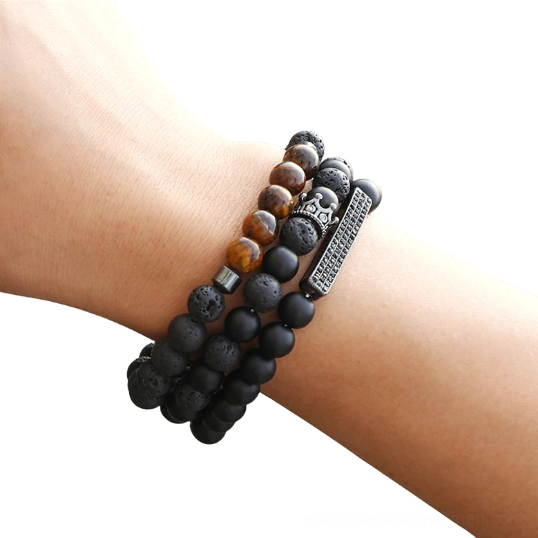 Black onyx beaded gothic bracelet with vintage crown charm on male wrist, matte stone beads close-up detail view