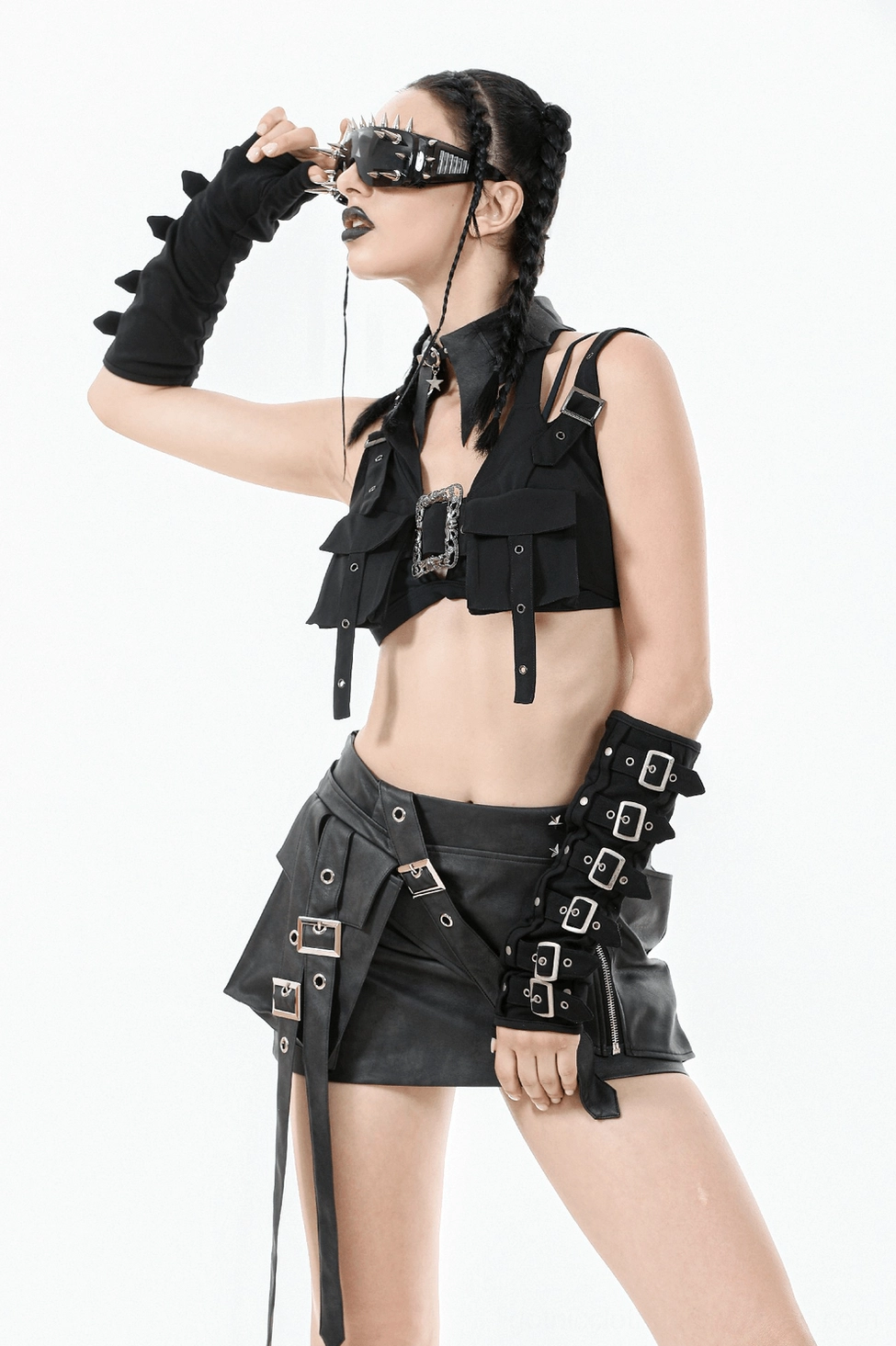 Black harness crop top with ornate silver buckles and grommet detailing photographed as standalone product display