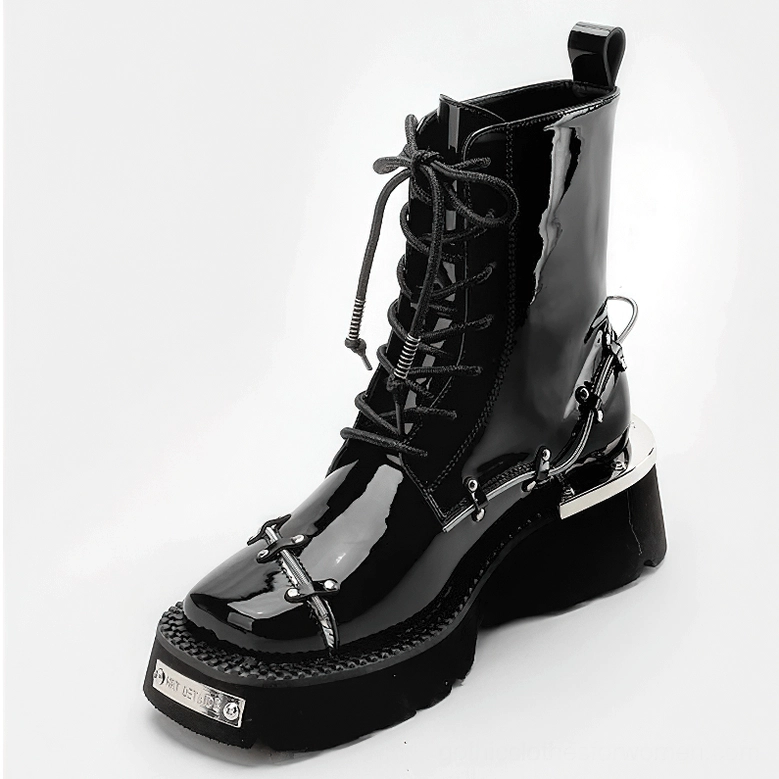 Single black patent leather gothic ankle boot showcasing pull tab collar, metal hardware, and platform block heel