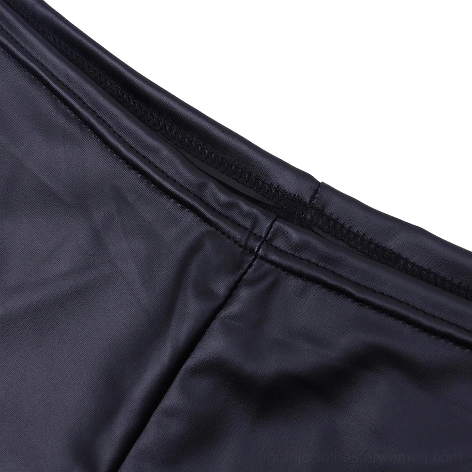 Close-up detail of smooth black patent leather fabric with precision stitched seams and high-gloss finish