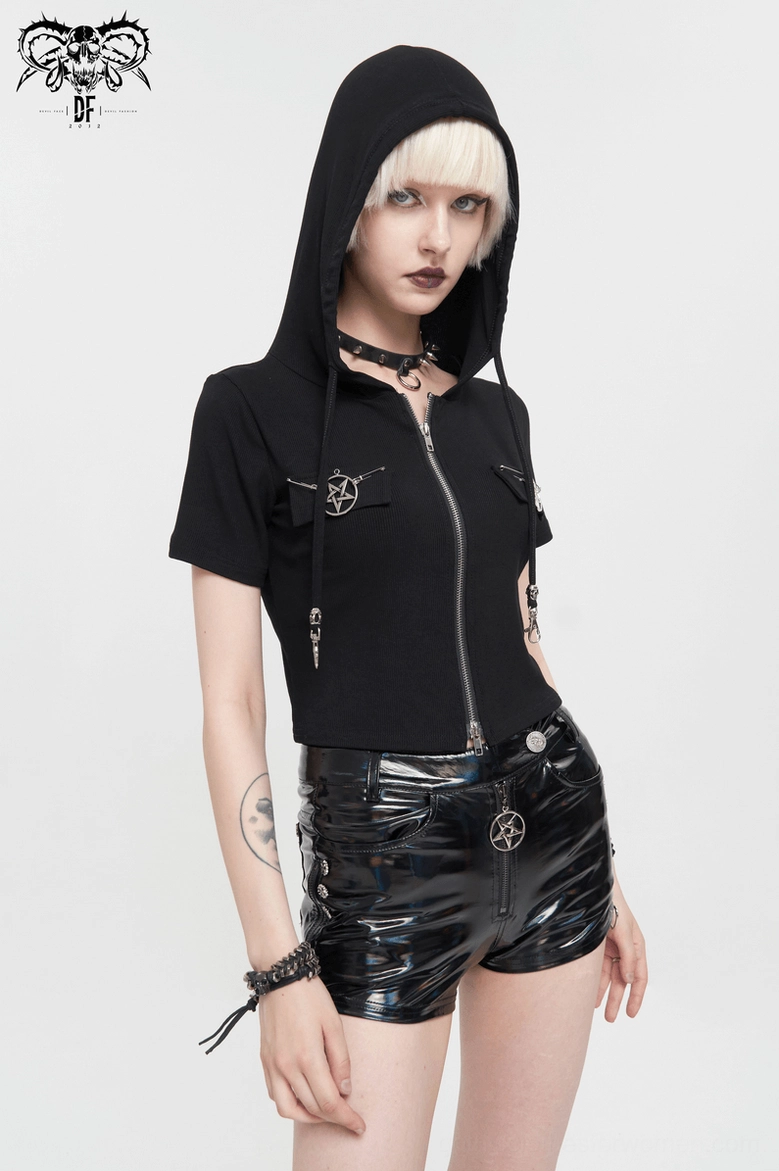 Goth model wearing black pentagram zip crop hooded top side three-quarter view with hood up, pentagram outfit details