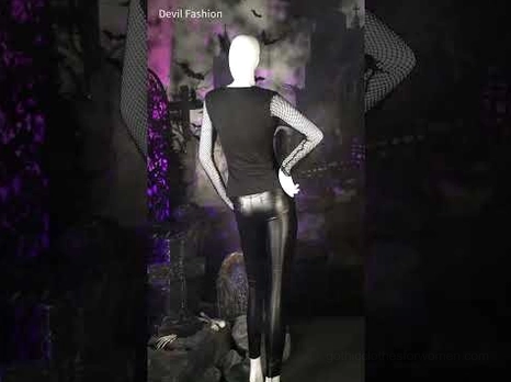 Black pentagram mesh long sleeve gothic top styled on mannequin with leather pants in gothic shop setting