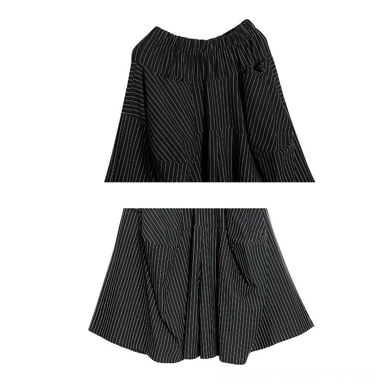 Close-up rear view of elastic waistband on black pinstripe gothic skirt, showing pinstripe texture and construction