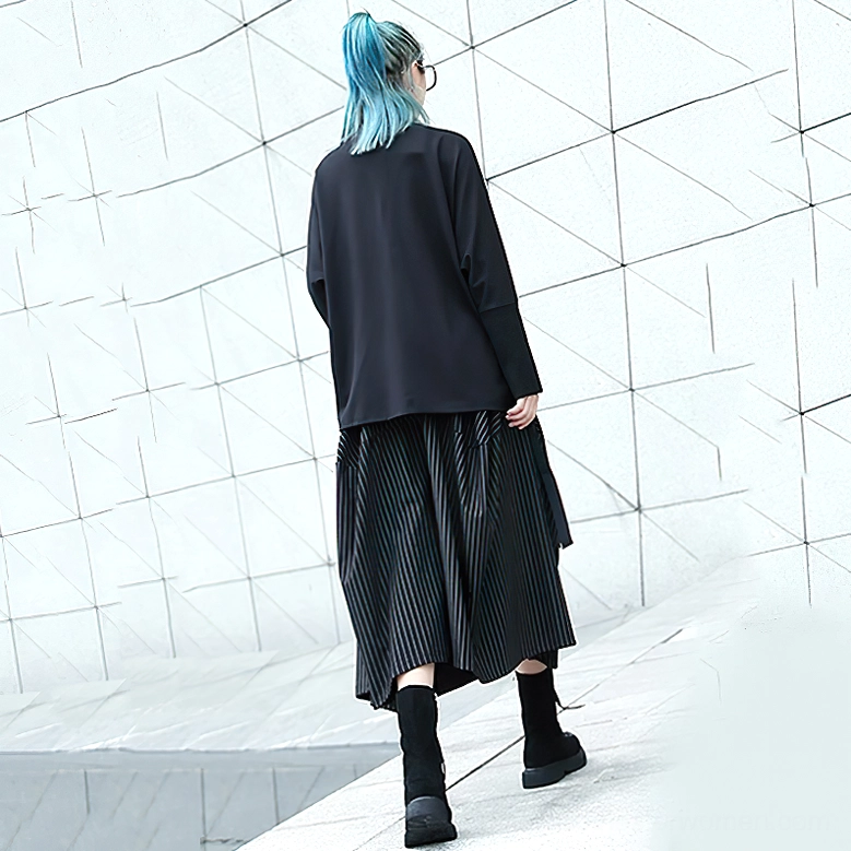 Back view of black pinstripe gothic skirt on model with alternative styling, showing loose silhouette and ankle-length cut