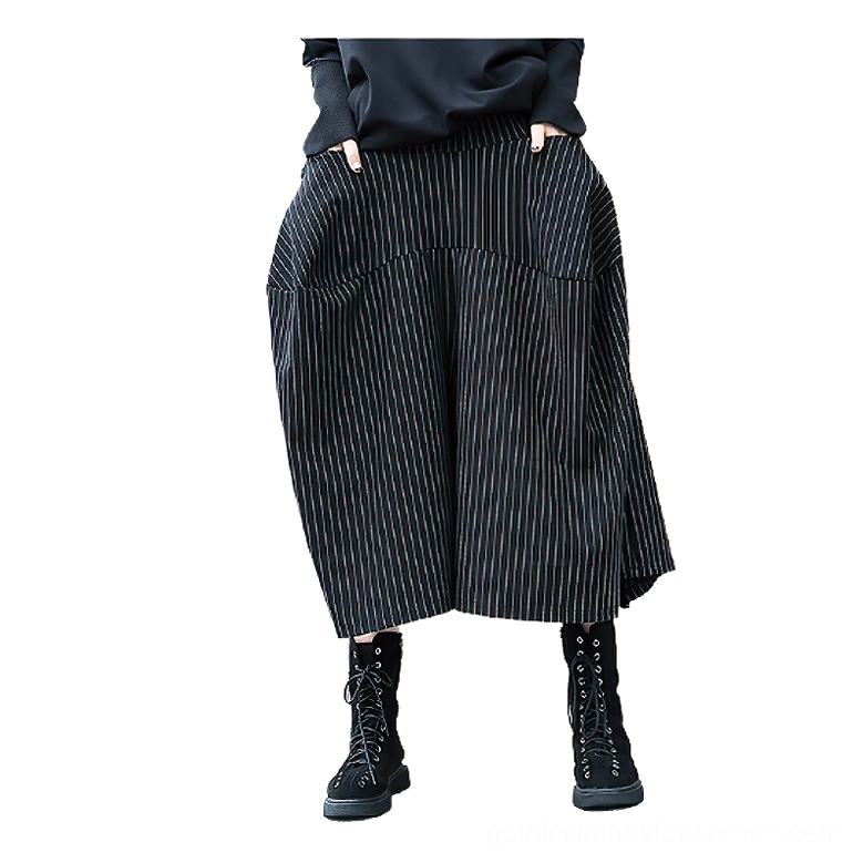 Front full-length view of black pinstripe gothic skirt on female model, featuring elastic waist and functional large side pockets
