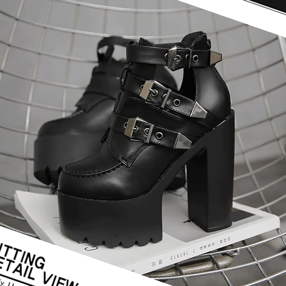 Black gothic platform boots front three-quarter view showcasing ridged textured platform sole and polished metal hardware details