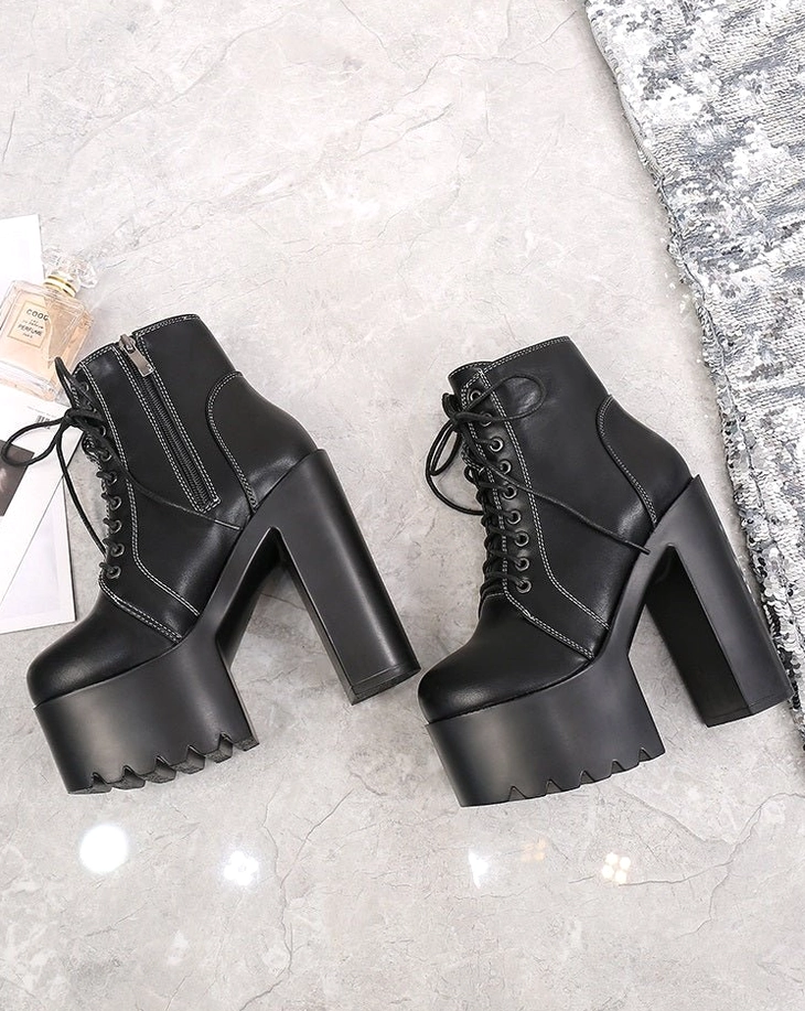 Black lace-up gothic platform ankle boots with thick sole and high block heel, flat lay top view