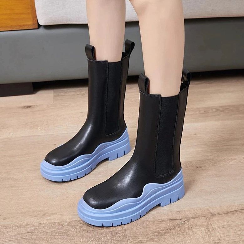 Black leather mid-calf platform chelsea boots worn styling, demonstrating versatile alternative fashion aesthetic with thick sole construction