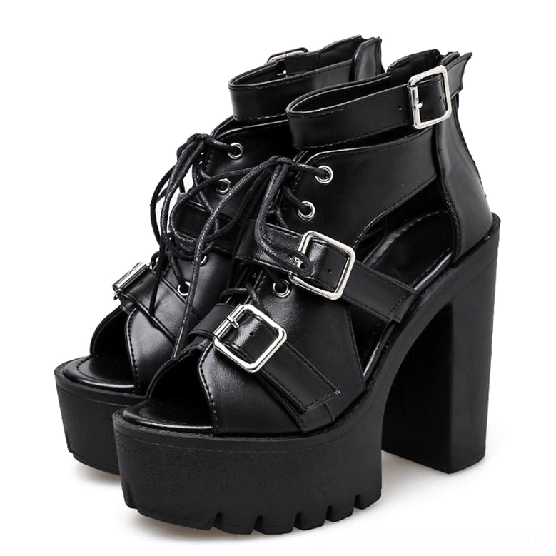 Pair of black platform sandals showing cutout ankle straps and faux leather material detail, studio white background