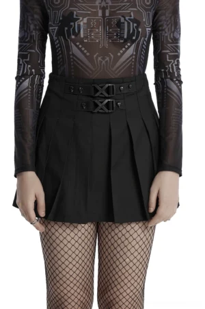 Black gothic pleated mini skirt with skull rivets and X-shaped buckles, front view on model with fishnet stockings