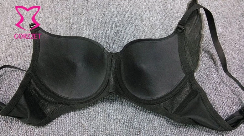 Back view of black studded bra showing molded cups, mesh panels, and structured support