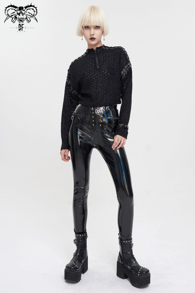 Full front view of black quilted gothic cropped top styled with high-waisted shiny pants and platform boots