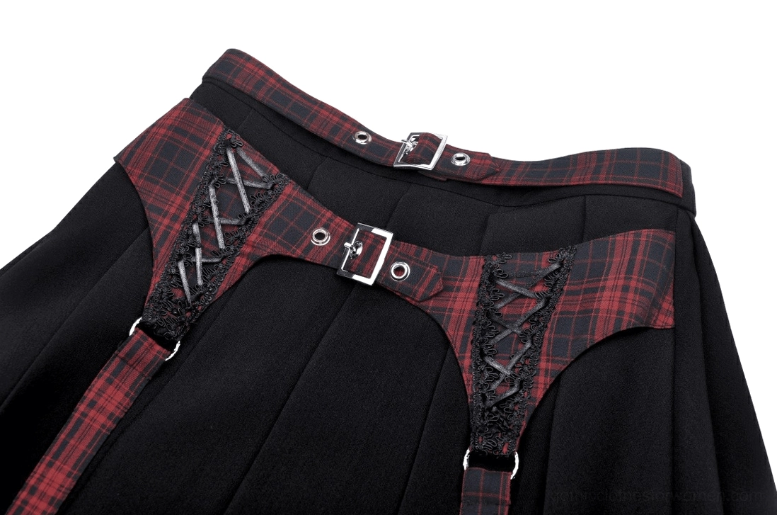 Close-up detail of red tartan harness with lace-up trim and metal hardware on gothic skirt
