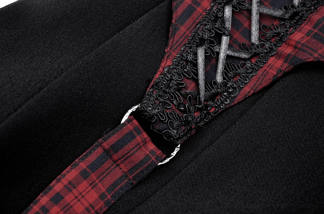 Close-up of red tartan lace-up strap with black lace trim and metal ring accents on gothic skirt