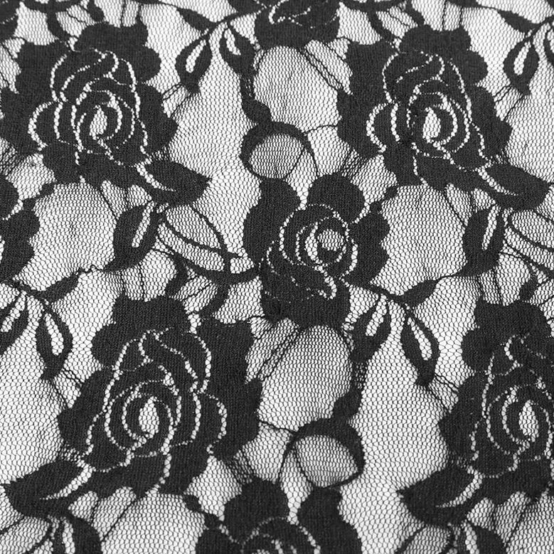 Macro texture detail of sheer black lace material on gothic flare leggings, featuring delicate rose floral lace pattern