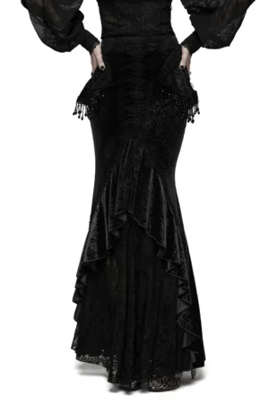 Black rose velvet fishtail skirt with lace detail, back three-quarter view showing beaded tassel accents and asymmetric ruffled hem