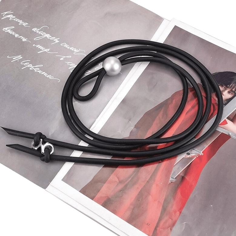 Black rubber gothic long necklace with silver bead and metal screw adjusters on fashion magazine