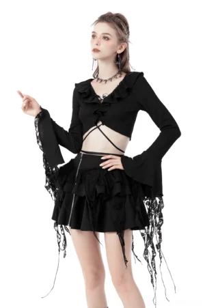 Black ruffle neck crop top with tassel ripped sleeves front three-quarter view on model