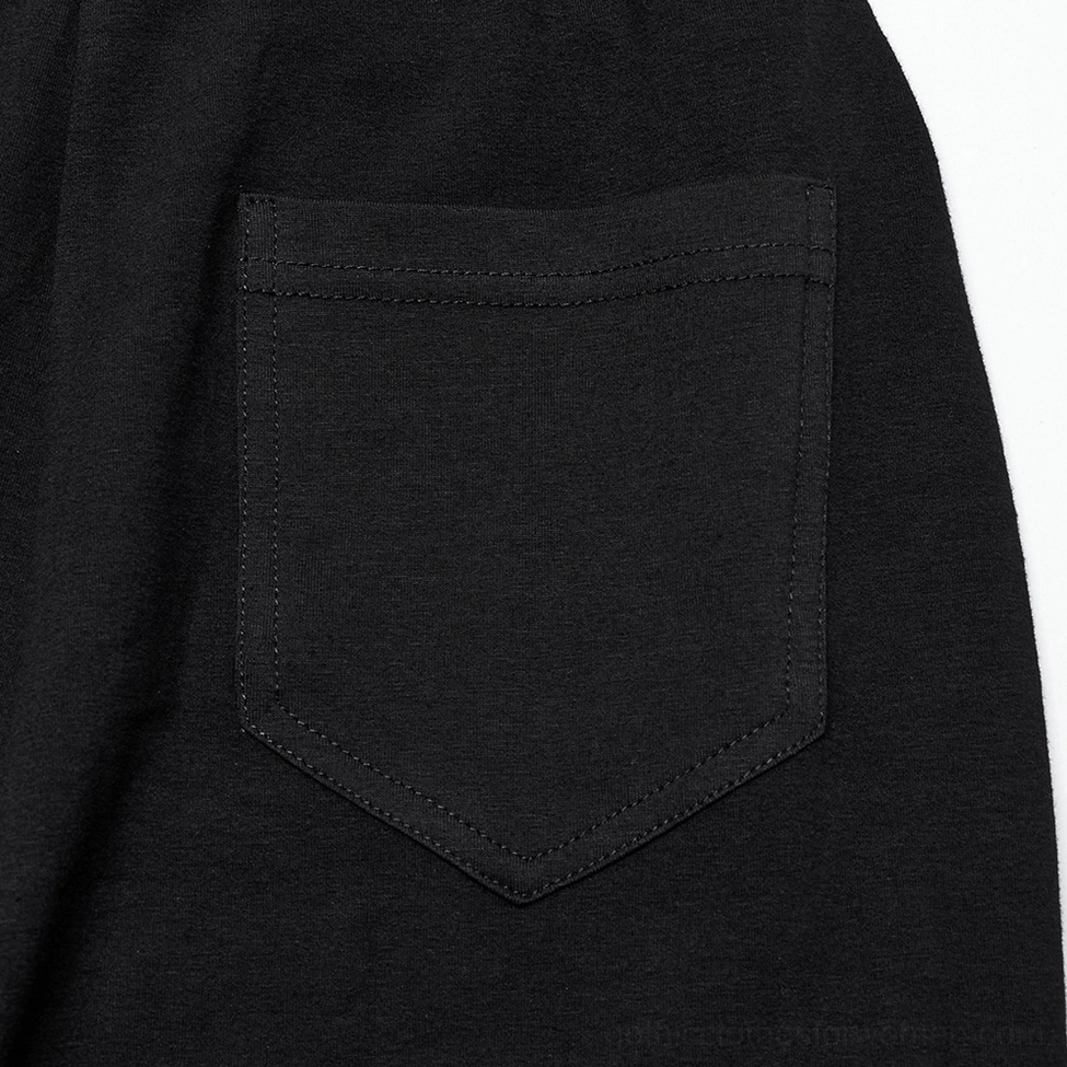 Black ruffle flare gothic pants front pocket close-up showing stitched patch pocket detail and knit fabric quality