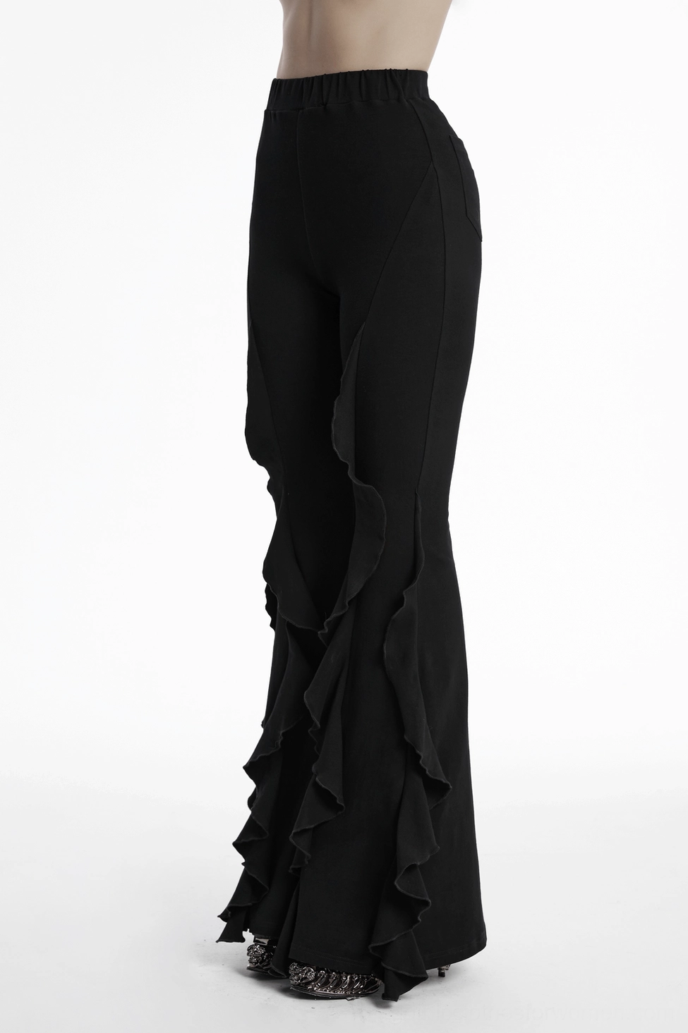 Black ruffle flare gothic pants styling detail with alternative fashion aesthetic and dark clothing composition